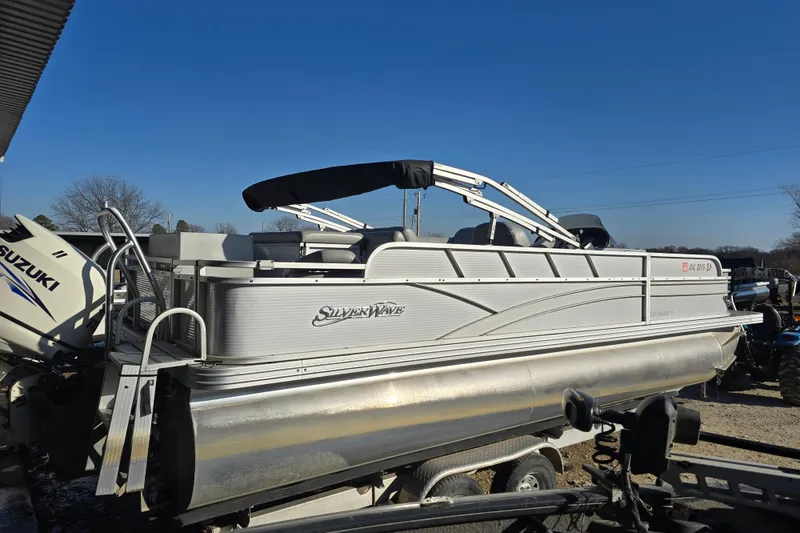 Slide: The Image of 2017 SilverWave 230 Island pontoon boat with Suzuki outboard motor, parked on trailer. - 2