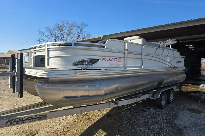 Slide: The Image of 2017 SilverWave 230 Island pontoon boat on trailer, parked outdoors. - 3
