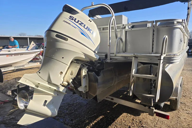 Slide: The Image of 2017 SilverWave 230 Island pontoon boat with Suzuki outboard motor, parked on a trailer. - 5