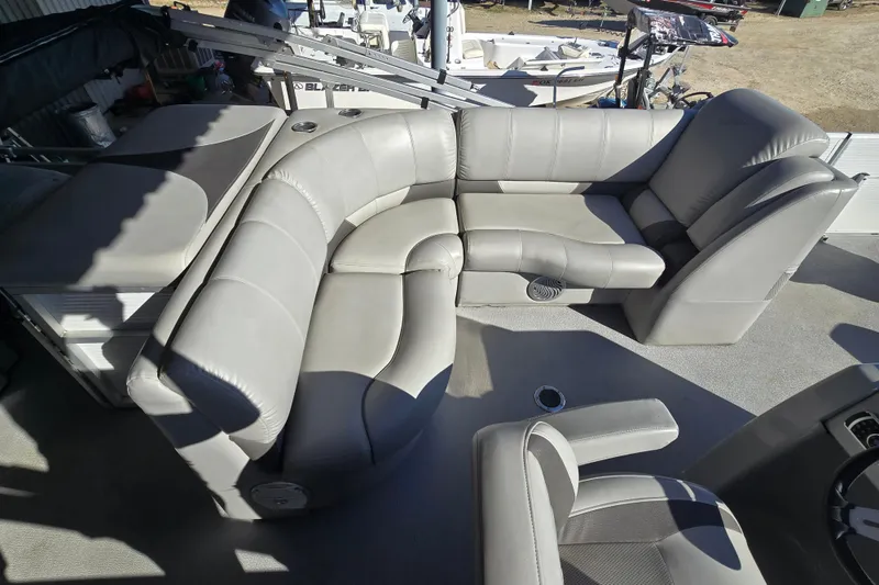 Slide: The Image of 2017 SilverWave 230 Island boat interior with gray leather seating and table. - 6