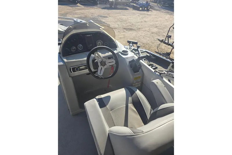 Slide: The Image of 2017 SilverWave 230 Island boat interior with steering wheel and dashboard controls. - 7