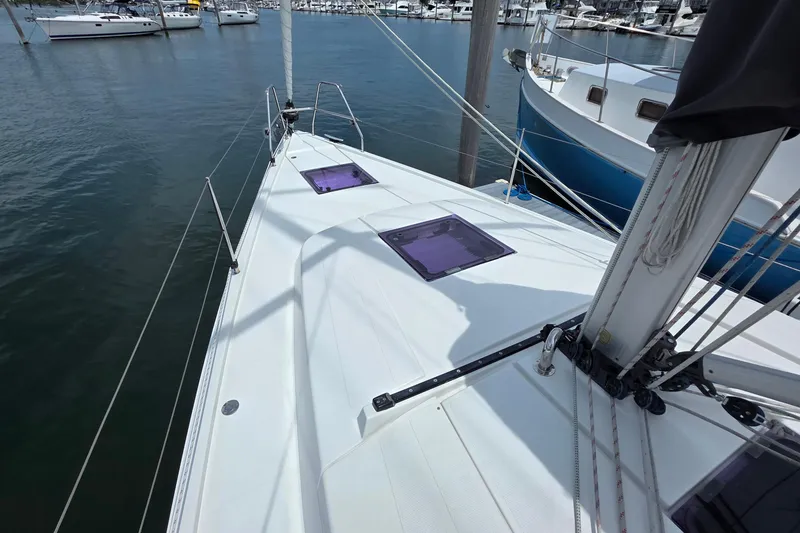 Slide: The Image of Sailboat deck view of 2014 Hanse 385 in marina, showcasing sleek design and rigging. - 10