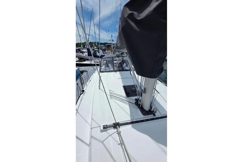 Slide: The Image of 2014 Hanse 385 sailboat deck view at marina, featuring mast and rigging. - 11
