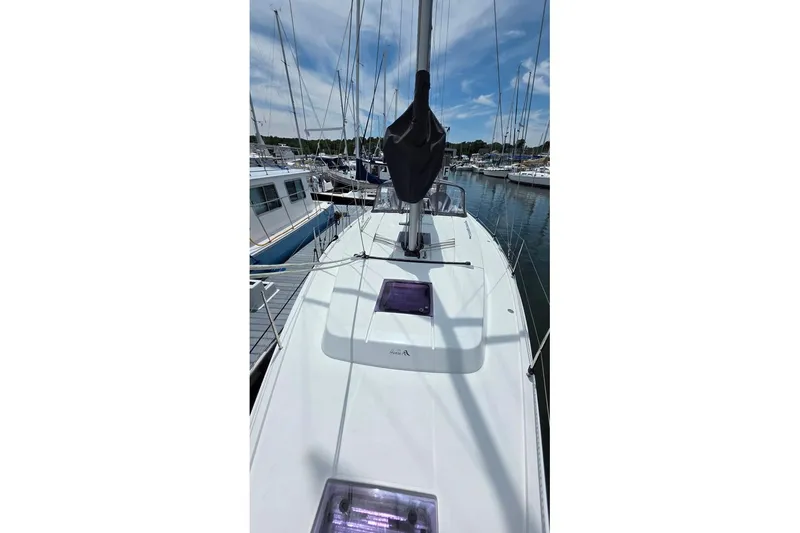 Slide: The Image of 2014 Hanse 385 sailboat docked at marina under clear sky. - 12