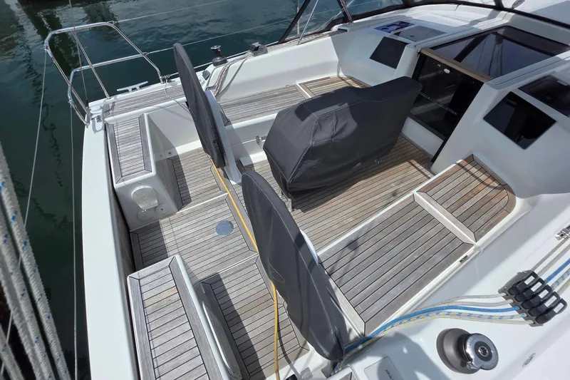 Slide: The Image of 2014 Hanse 385 yacht cockpit with teak flooring and covered seating. - 14