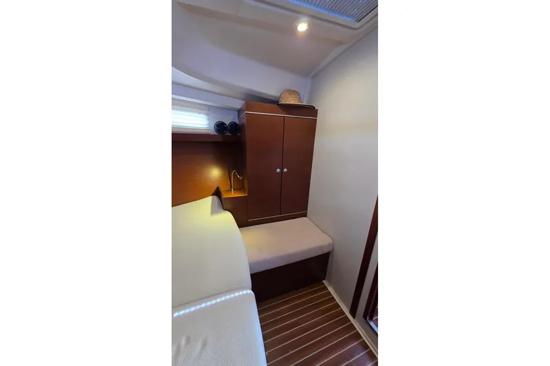 Slide: The Image of Cozy cabin interior of 2014 Hanse 385 yacht with wooden cabinetry and soft lighting. - 21