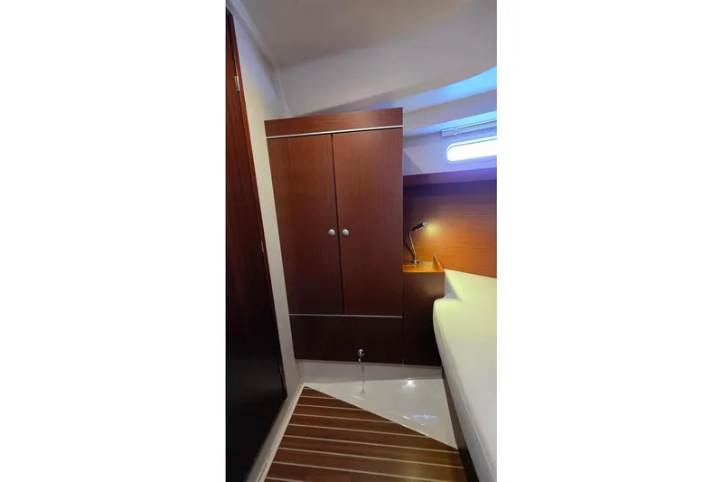 Slide: The Image of Interior of 2014 Hanse 385 yacht cabin with wooden cabinetry and modern lighting. - 22