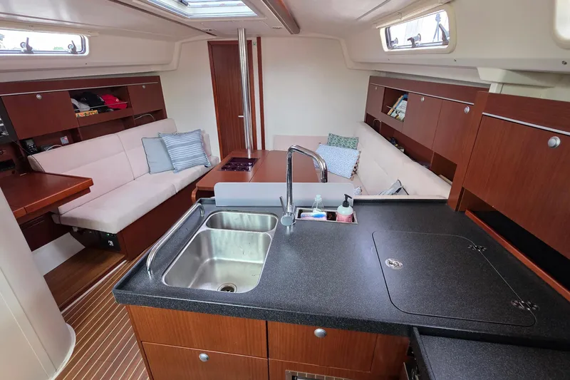 Slide: The Image of Interior of 2014 Hanse 385 yacht with modern kitchen and cozy seating area. - 23