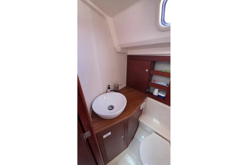 Slide: The Image of 2014 Hanse 385 yacht bathroom with modern sink and wooden cabinetry. - 26