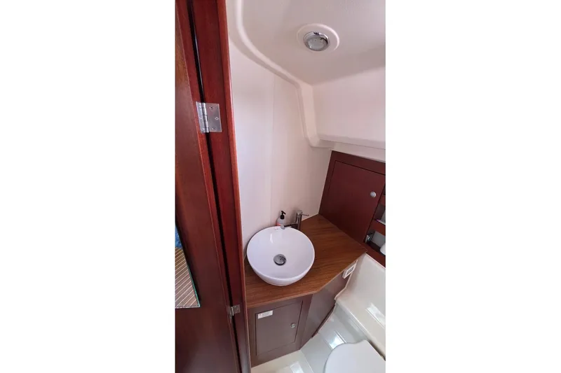 Slide: The Image of Bathroom interior of 2014 Hanse 385 yacht with modern sink and wooden cabinetry. - 27