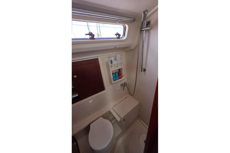 Slide: The Image of 2014 Hanse 385 yacht bathroom with shower, toilet, and storage cabinet. - 28