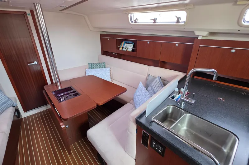 Slide: The Image of Interior of 2014 Hanse 385 yacht with cozy seating and modern kitchen area. - 29