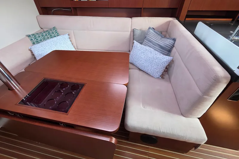Slide: The Image of Luxurious 2014 Hanse 385 yacht interior with cozy seating and elegant wooden table. - 31