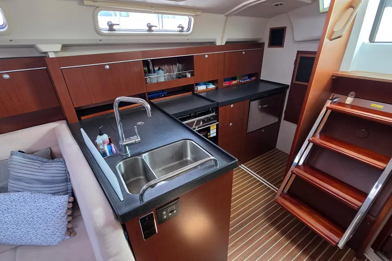 Slide: The Image of Interior of 2014 Hanse 385 yacht featuring modern kitchen and wooden cabinetry. - 32