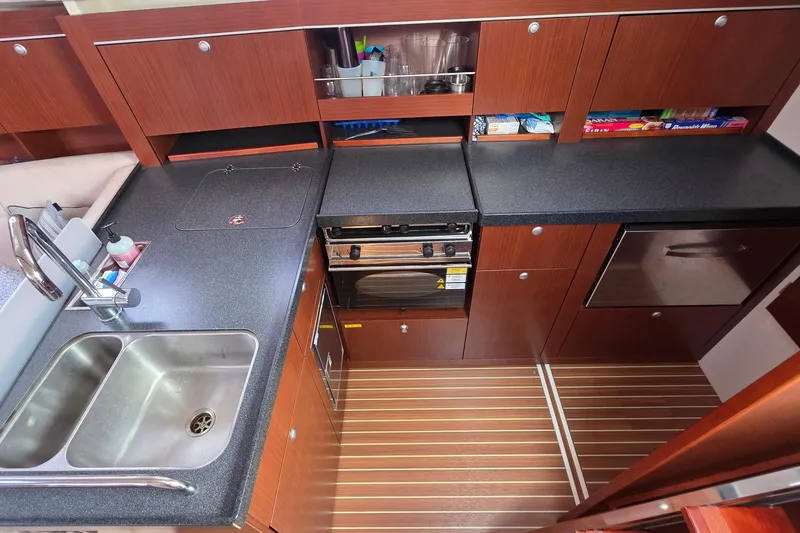 Slide: The Image of Modern kitchen in 2014 Hanse 385 yacht with wood cabinets and dual sink. - 34