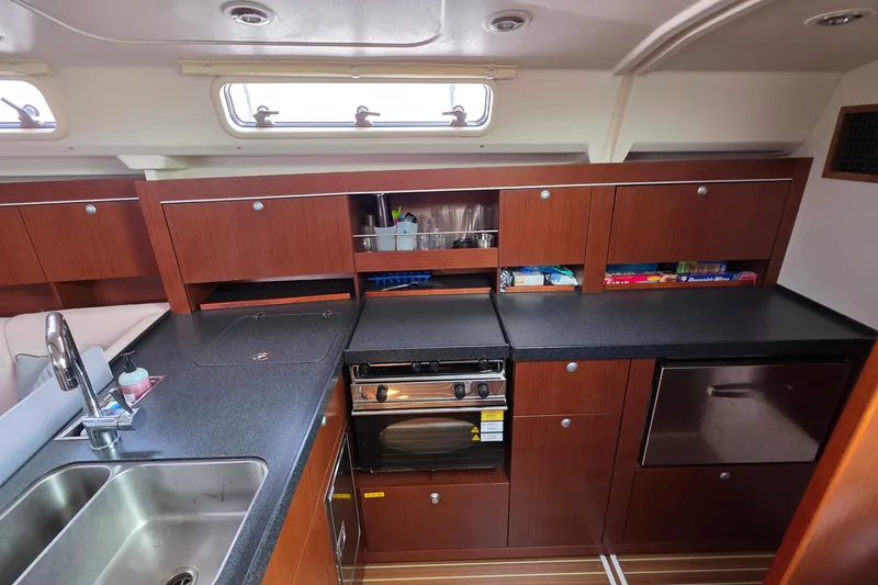 Slide: The Image of Modern kitchen interior of 2014 Hanse 385 yacht with wooden cabinets and stainless steel sink. - 35