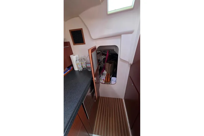 Slide: The Image of Interior of 2014 Hanse 385 yacht with storage area and countertop essentials. - 36
