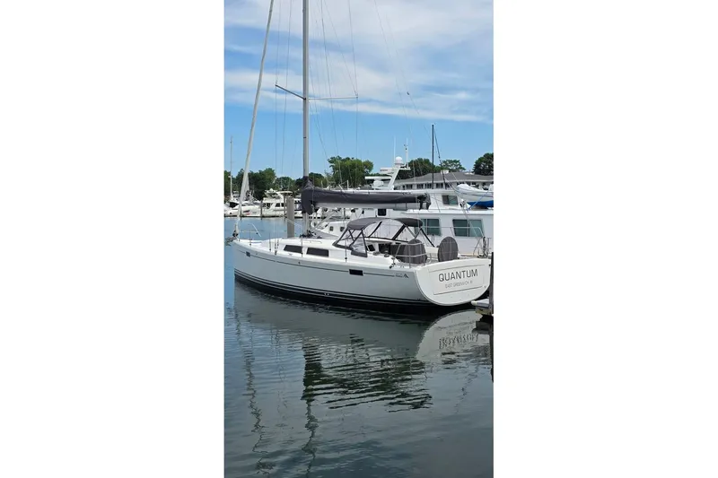 Slide: The Image of 2014 Hanse 385 sailboat docked in a marina, clear sky reflection on water. - 4