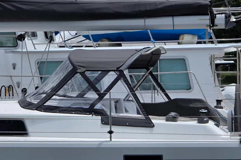 Slide: The Image of 2014 Hanse 385 sailboat with protective canopy and sleek design. - 6