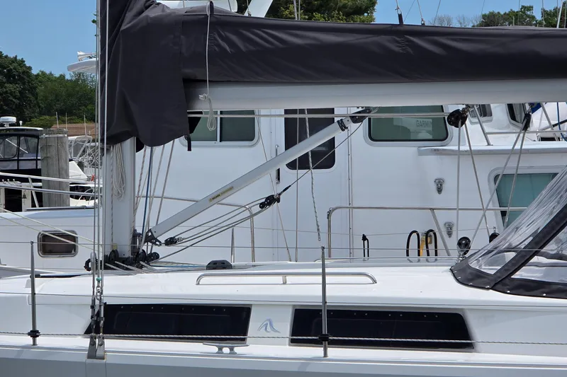 Slide: The Image of 2014 Hanse 385 sailboat docked, featuring sleek design and modern rigging. - 7