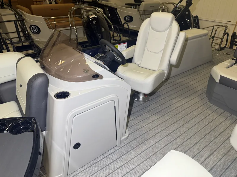 Slide: The Image of The image shows the cockpit of a 2026 Starcraft EX 20 Q DH with comfortable seating and a modern helm. - 19