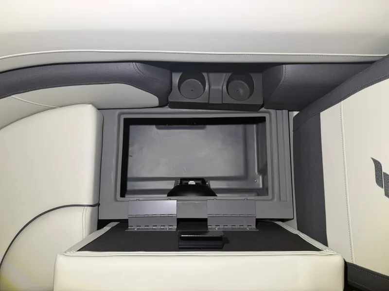Slide: The Image of An open storage compartment on a boat with cushioned seating and cup holders. - 13
