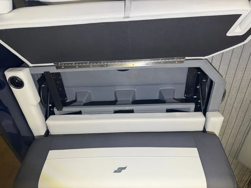 Slide: The Image of The interior view of a Starcraft EX 20 Q DH boat shows a cushioned bench seat with storage underneath. - 36