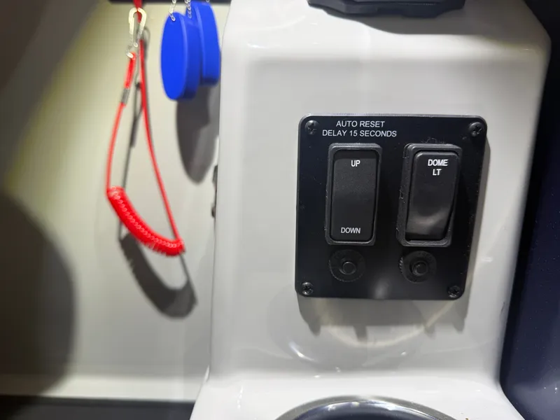Slide: The Image of Close-up of switches and a red safety cord on a boat. - 31