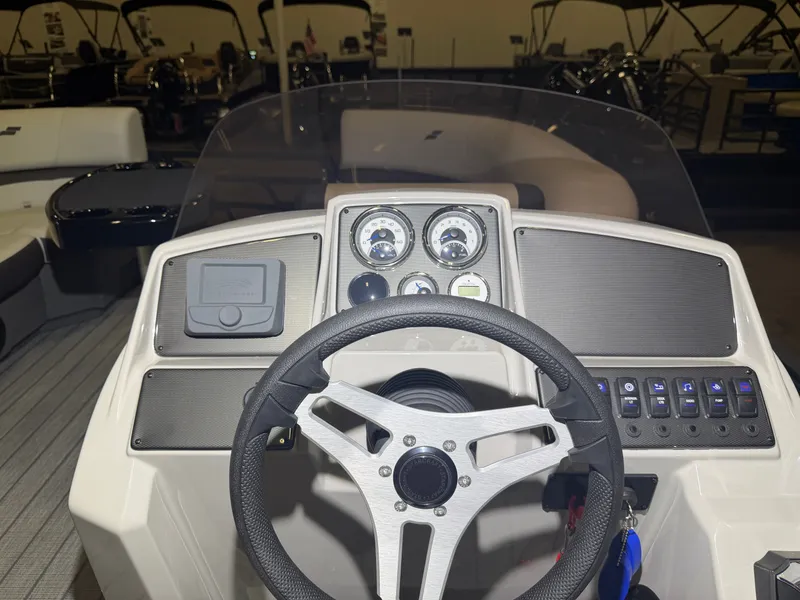 Slide: The Image of The image shows the helm of a Starcraft EX 20 Q DH boat with modern instruments. - 26