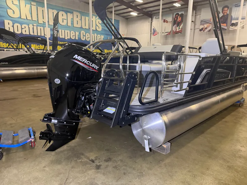 Slide: The Image of A Starcraft EX 20 Q DH pontoon boat with a Mercury outboard motor in a showroom. - 43