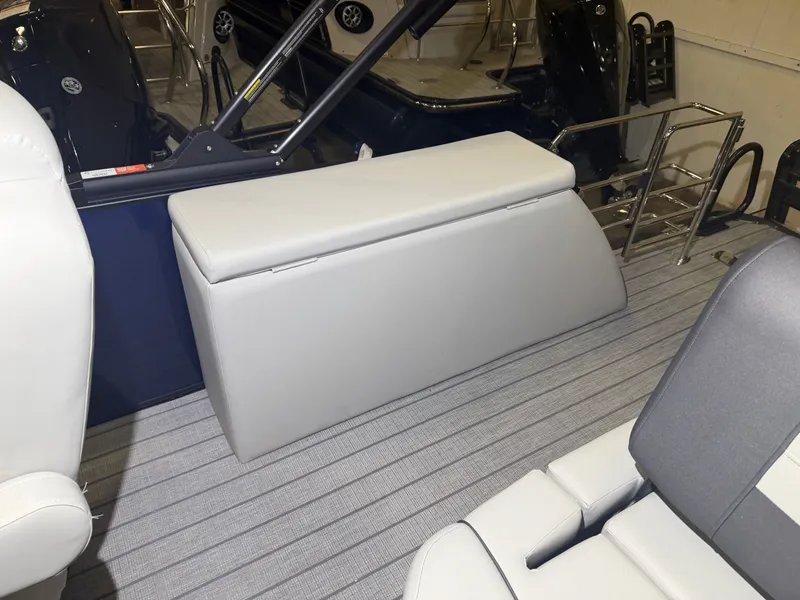 Slide: The Image of The image shows the interior of a Starcraft EX 20 Q DH boat with gray upholstery and a metal railing. - 37