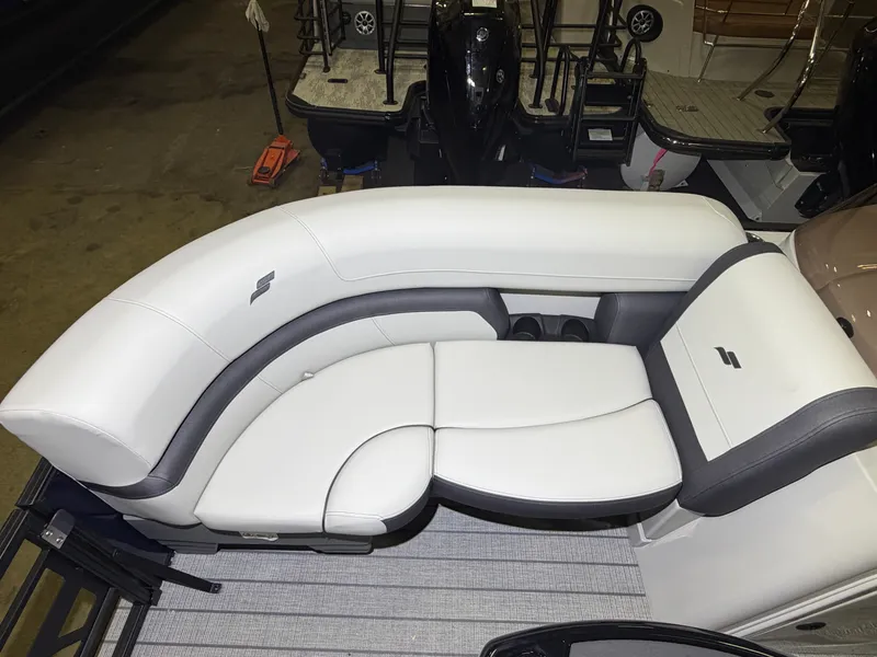Slide: The Image of The image shows a luxurious white seating area on a boat, surrounded by dark accents. - 11