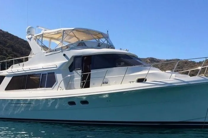 The Image of Luxury 2002 Hampton 550 yacht cruising on clear blue water. - 0