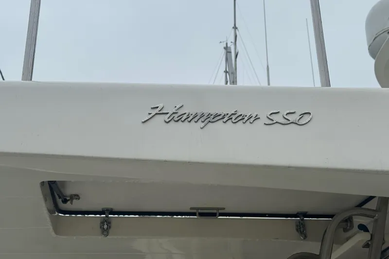 Slide: The Image of 2002 Hampton 550 yacht with elegant script logo on the hull. - 12
