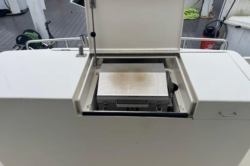 Slide: The Image of Outdoor grill on a 2002 Hampton 550 yacht deck, with storage compartment open. - 16