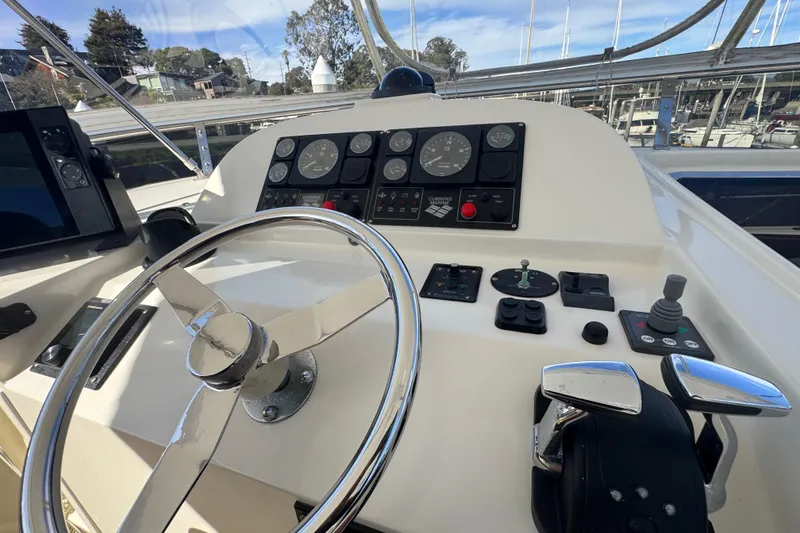 Slide: The Image of Helm of 2002 Hampton 550 yacht with steering wheel and control panel. - 19