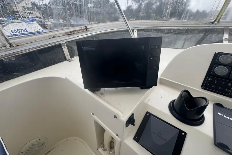 Slide: The Image of Helm of 2002 Hampton 550 yacht with navigation equipment and controls. - 20