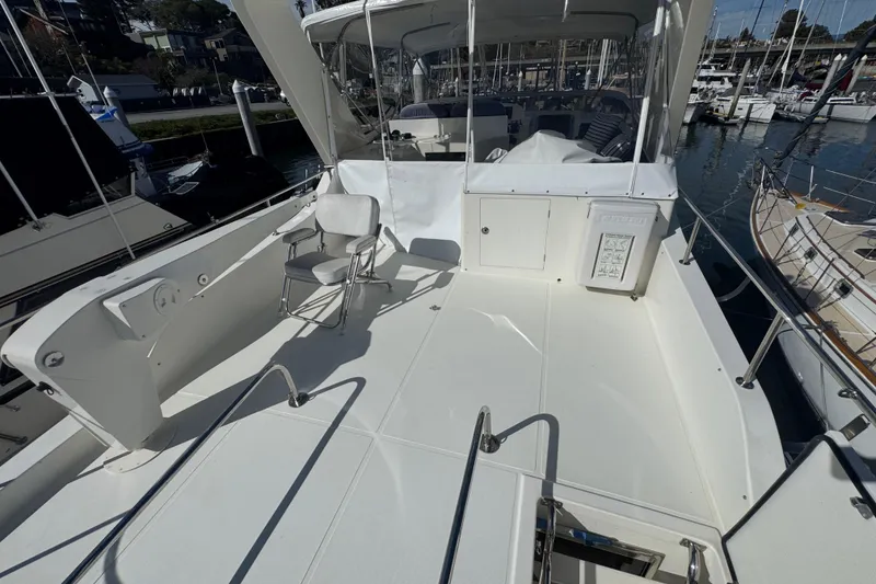 Slide: The Image of 2002 Hampton 550 yacht deck with seating, docked at marina. - 27