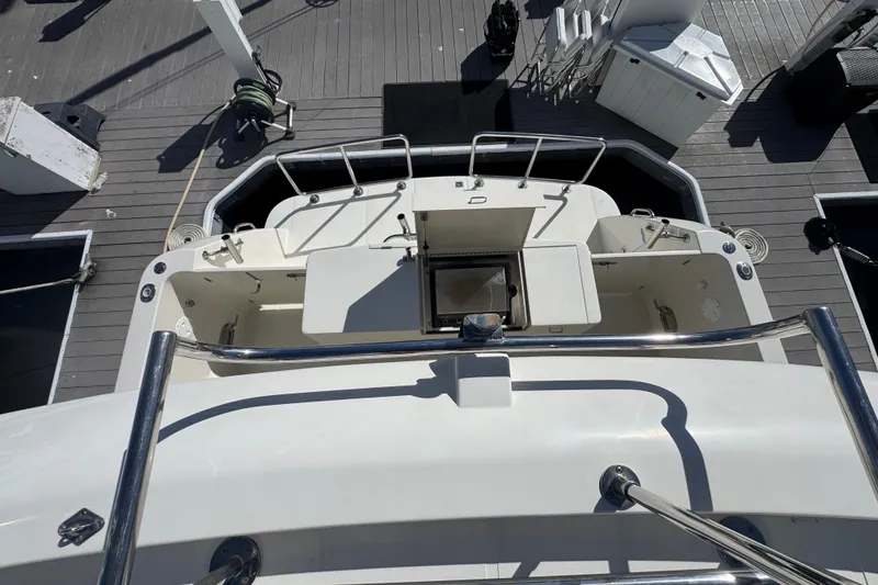 Slide: The Image of 2002 Hampton 550 yacht deck with stainless steel railings and dock view. - 29