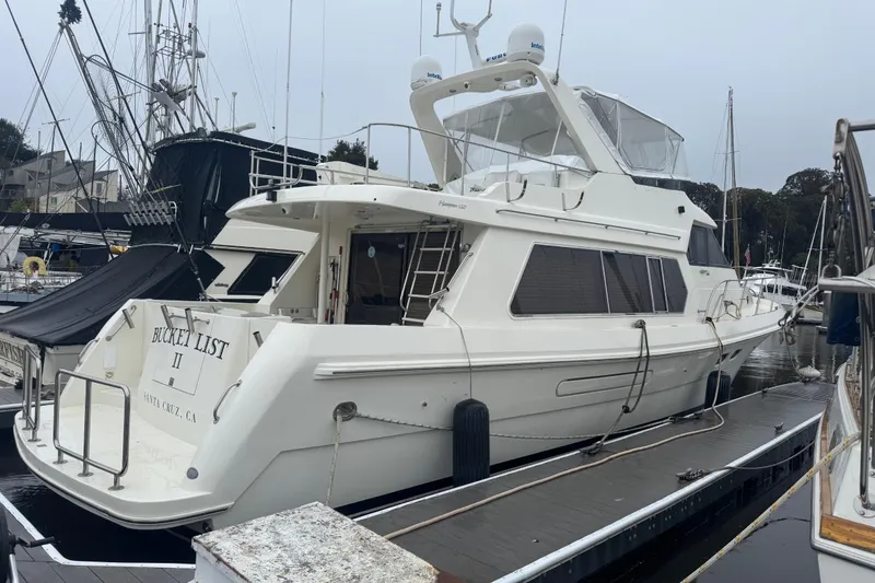 Slide: The Image of 2002 Hampton 550 yacht docked in marina, labeled "Bucket List II," Santa Cruz, CA. - 3