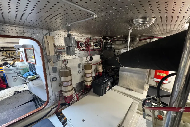 Slide: The Image of Engine room of a 2002 Hampton 550 yacht, showcasing mechanical components and equipment. - 30