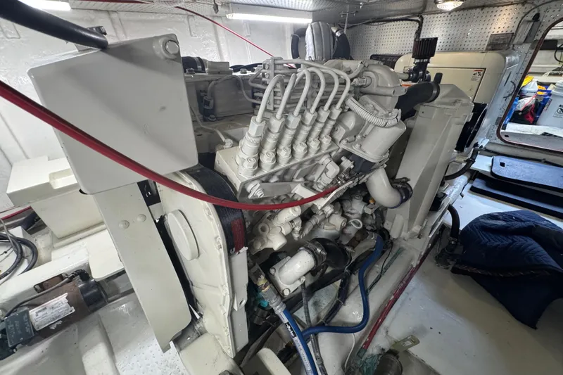 Slide: The Image of Engine room of a 2002 Hampton 550 with intricate piping. - 34