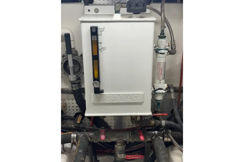 Slide: The Image of Engine room equipment in a 2002 Hampton 550 yacht, featuring a Wesmar stabilizer system. - 35