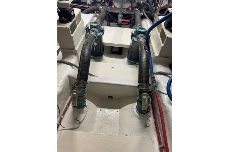 Slide: The Image of Engine room of a 2002 Hampton 550 yacht with visible hoses and fittings. - 36