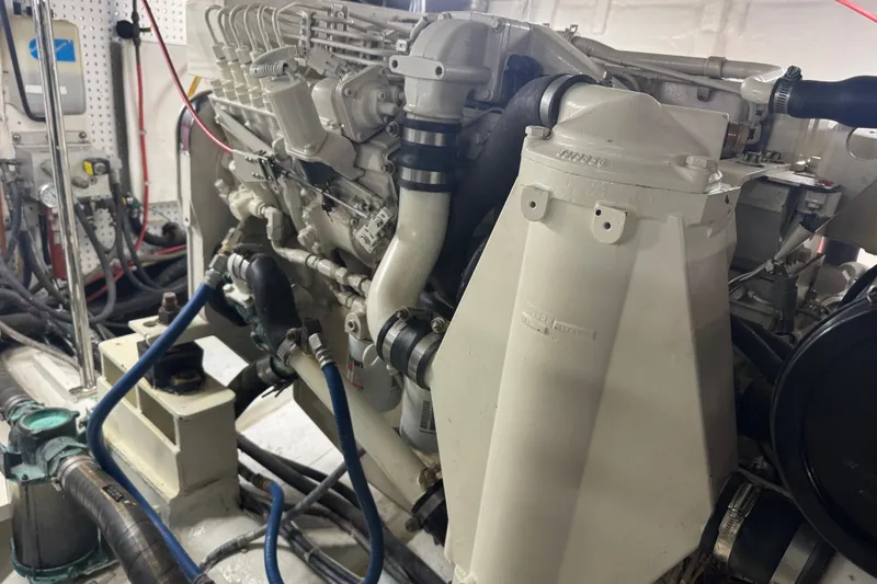 Slide: The Image of Engine room of a 2002 Hampton 550 yacht, showcasing detailed machinery and components. - 38