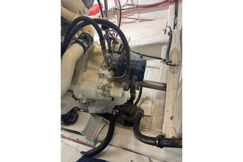 Slide: The Image of Engine compartment of a 2002 Hampton 550 yacht, showcasing mechanical components and wiring. - 39