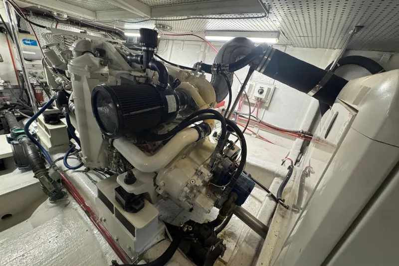 Slide: The Image of Engine room of a 2002 Hampton 550 yacht, showcasing detailed machinery and components. - 43