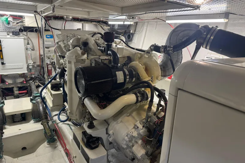 Slide: The Image of Engine room of a 2002 Hampton 550 yacht, showcasing detailed mechanical components. - 46