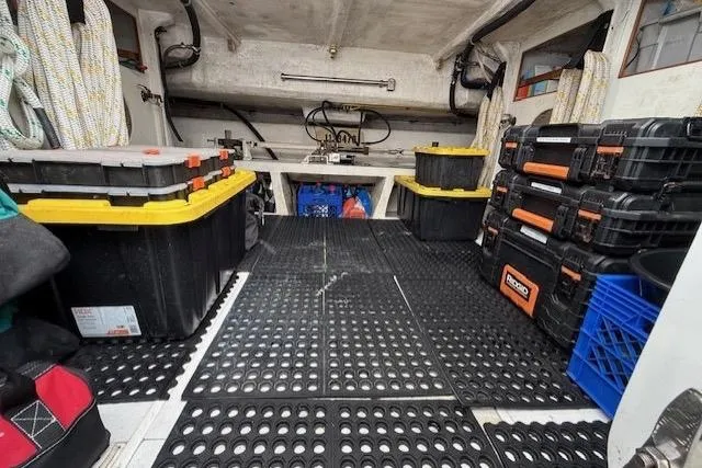 Slide: The Image of Interior of a 2002 Hampton 550 boat with organized storage boxes and equipment. - 47