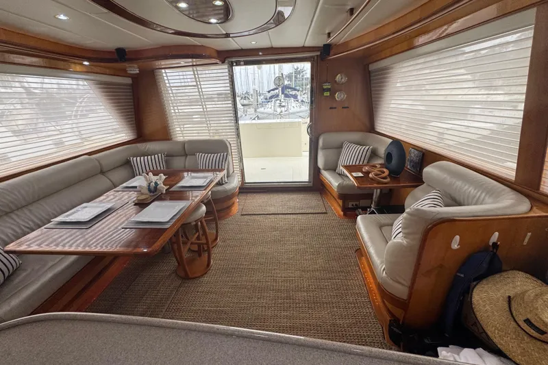 Slide: The Image of Luxurious 2002 Hampton 550 yacht interior with elegant seating and dining area. - 51